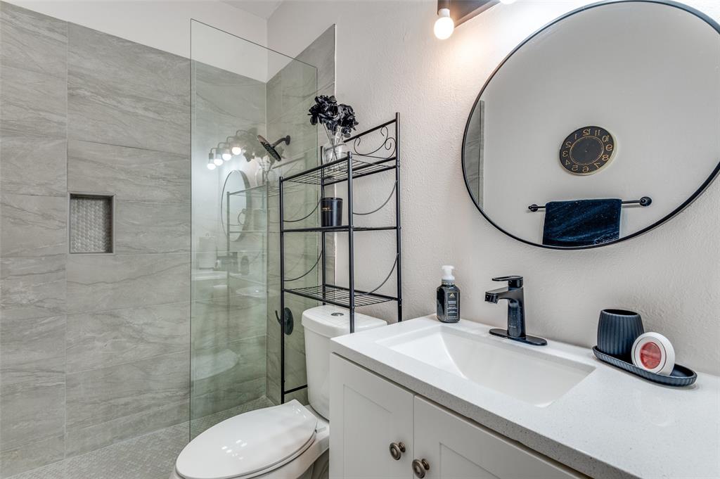 2110 Randy Snow Road, Unit 313 Arlington, TX 76011 - Photo 20 of 25 a bathroom with a sink mirror and toilet