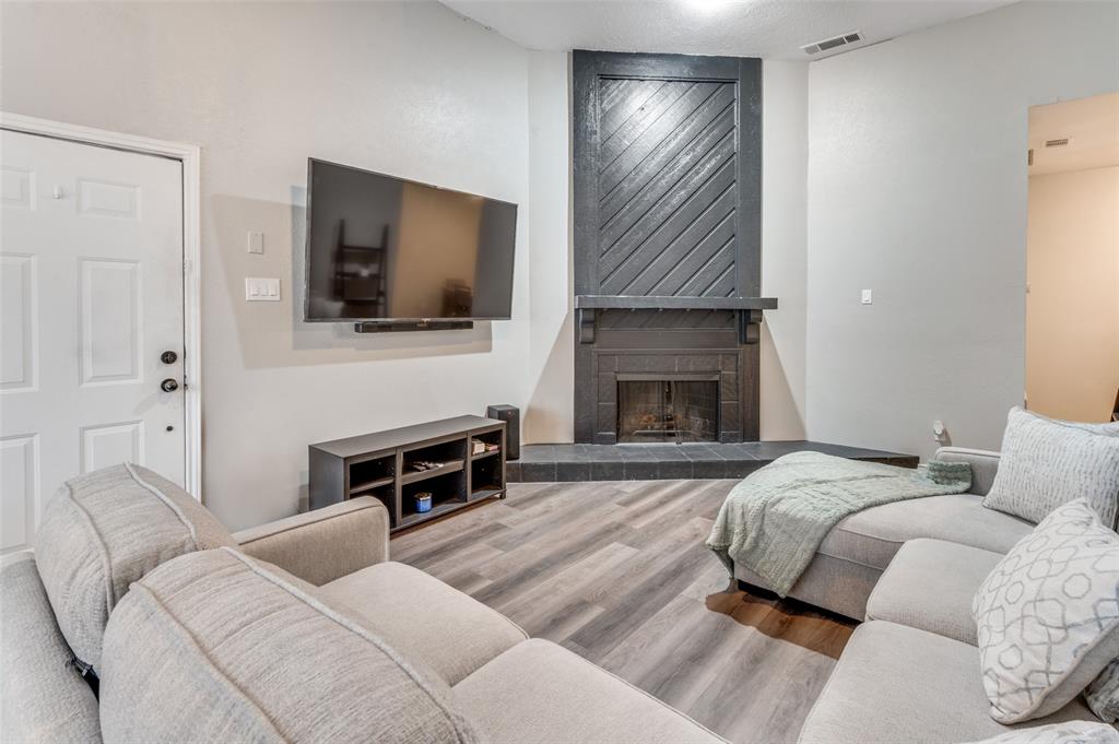 2110 Randy Snow Road, Unit 313 Arlington, TX 76011 - Photo 2 of 25 a bedroom with a bed and a fireplace