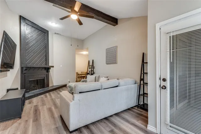 a living room with furniture a fireplace and a flat screen tv