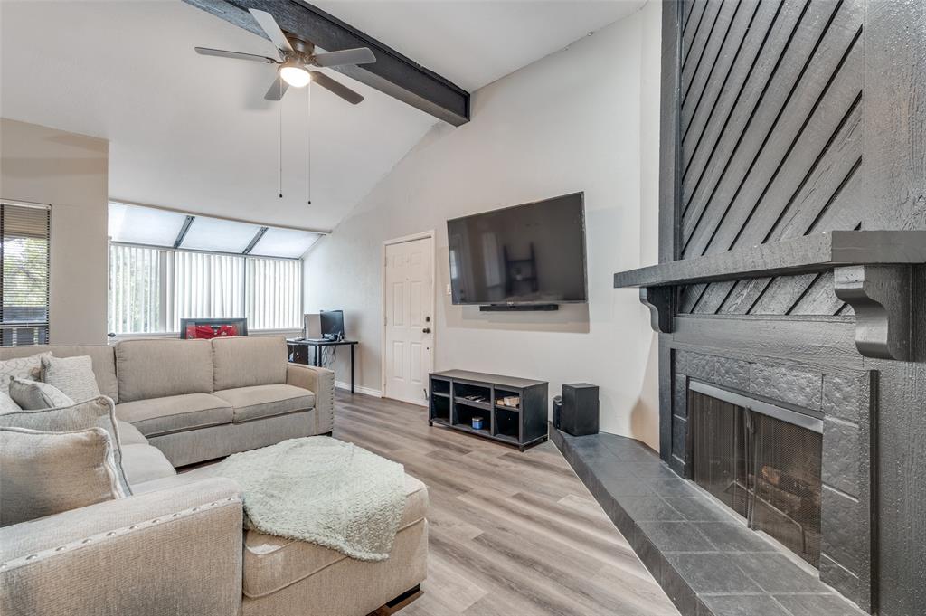 2110 Randy Snow Road, Unit 313 Arlington, TX 76011 - Photo 6 of 25 a living room with furniture a flat screen tv and a fireplace