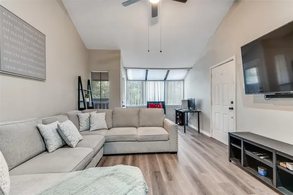 a living room with furniture and a flat screen tv
