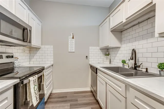 a kitchen that has a sink and a stove