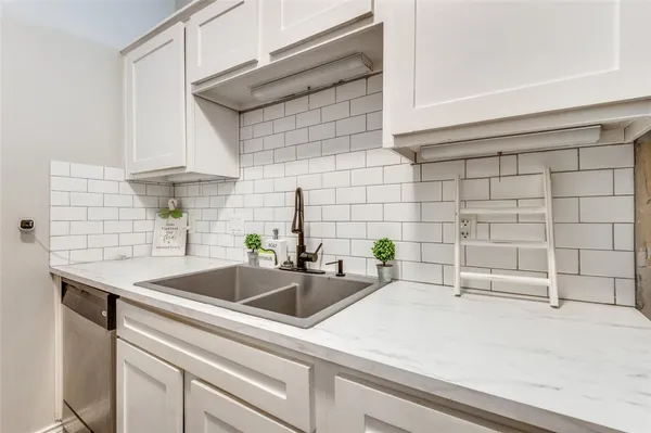 a kitchen with a sink and cabinets