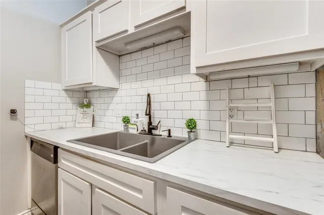 a kitchen with a sink and cabinets