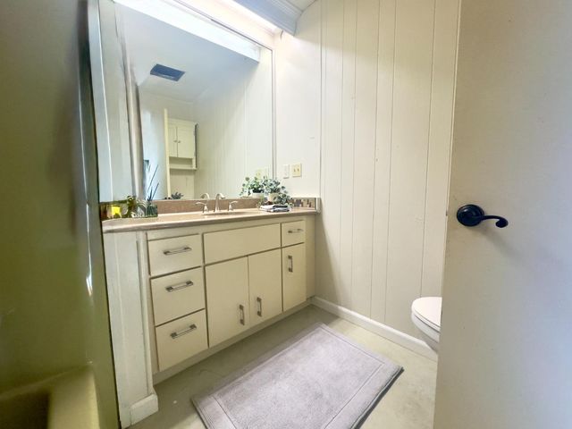 a bathroom with a sink a toilet and mirror