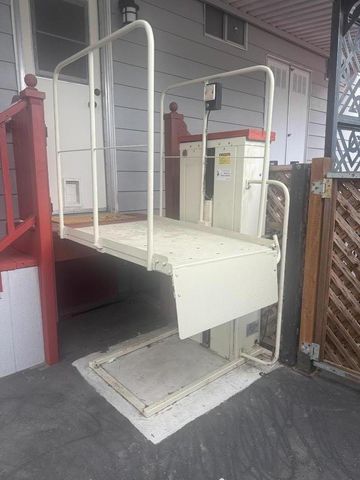 a view of a house with backyard and sitting area