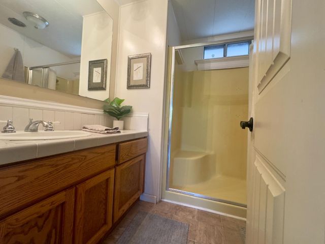 a bathroom with a sink a mirror and a shower