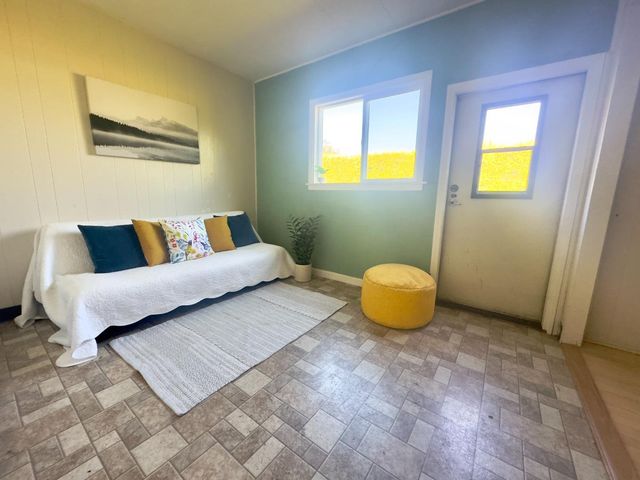 a bedroom with a bed and painting on the wall