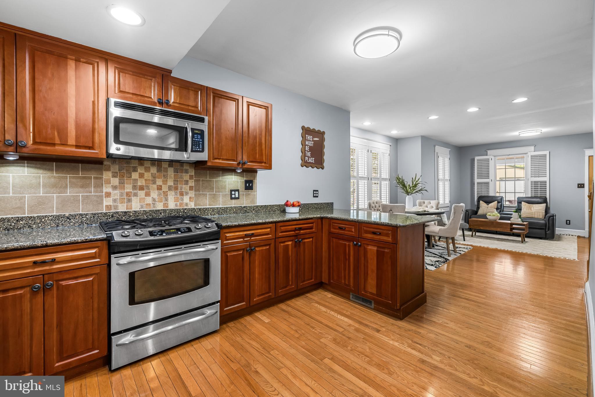 526 Hawthorne Road Linthicum Heights, MD 21090 - Photo 15 of 50 a kitchen with stainless steel appliances granite countertop wooden cabinets a stove a sink and a microwave
