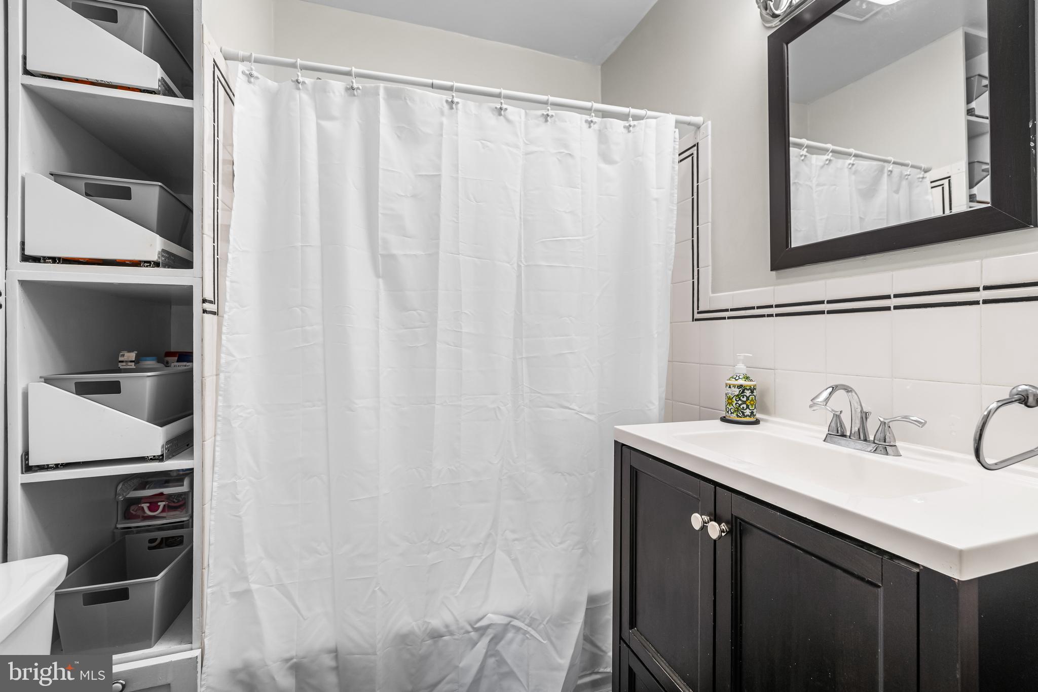 526 Hawthorne Road Linthicum Heights, MD 21090 - Photo 25 of 50 a bathroom with a sink and a mirror
