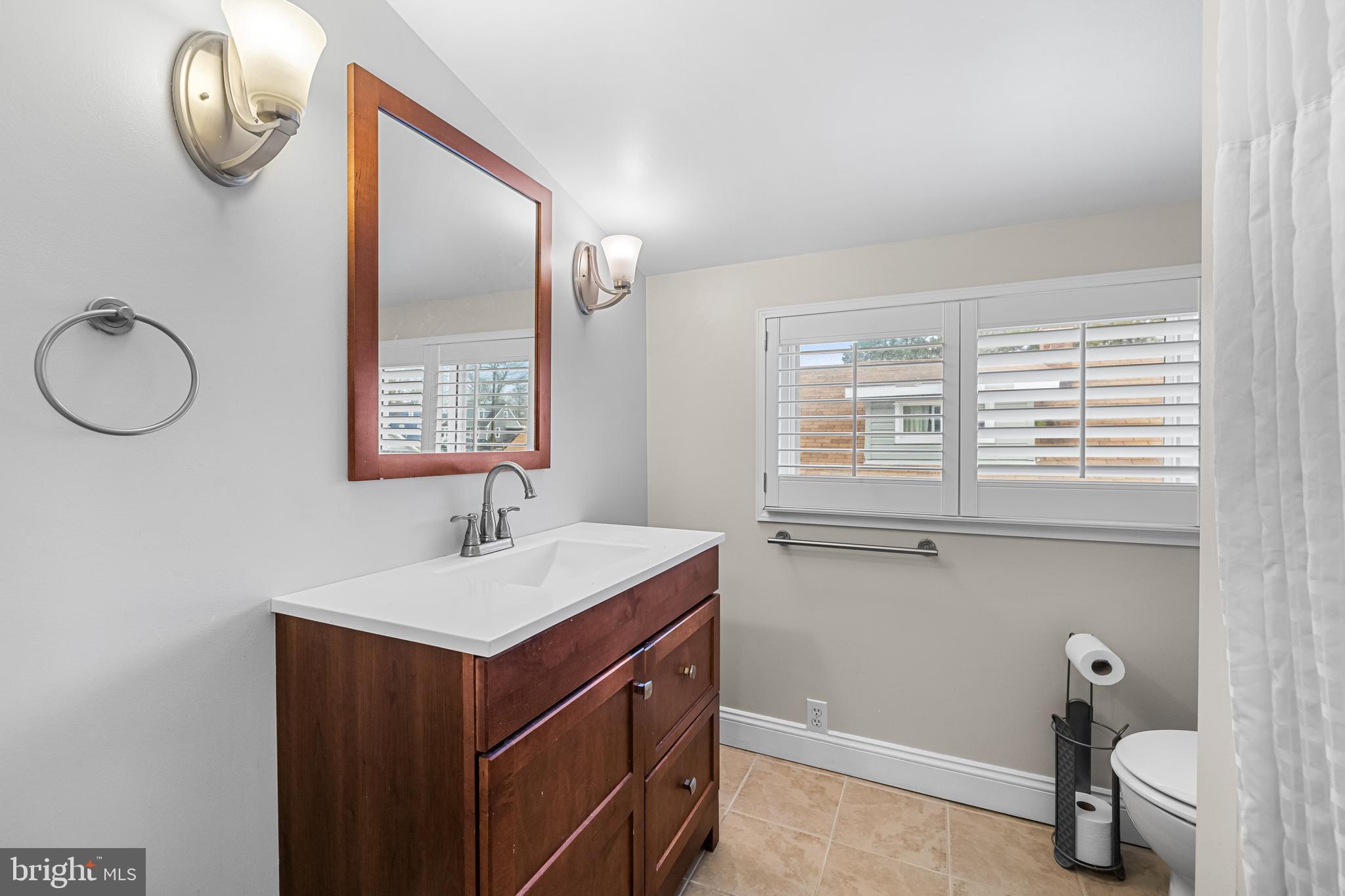 526 Hawthorne Road Linthicum Heights, MD 21090 - Photo 31 of 50 a bathroom with a sink and a mirror