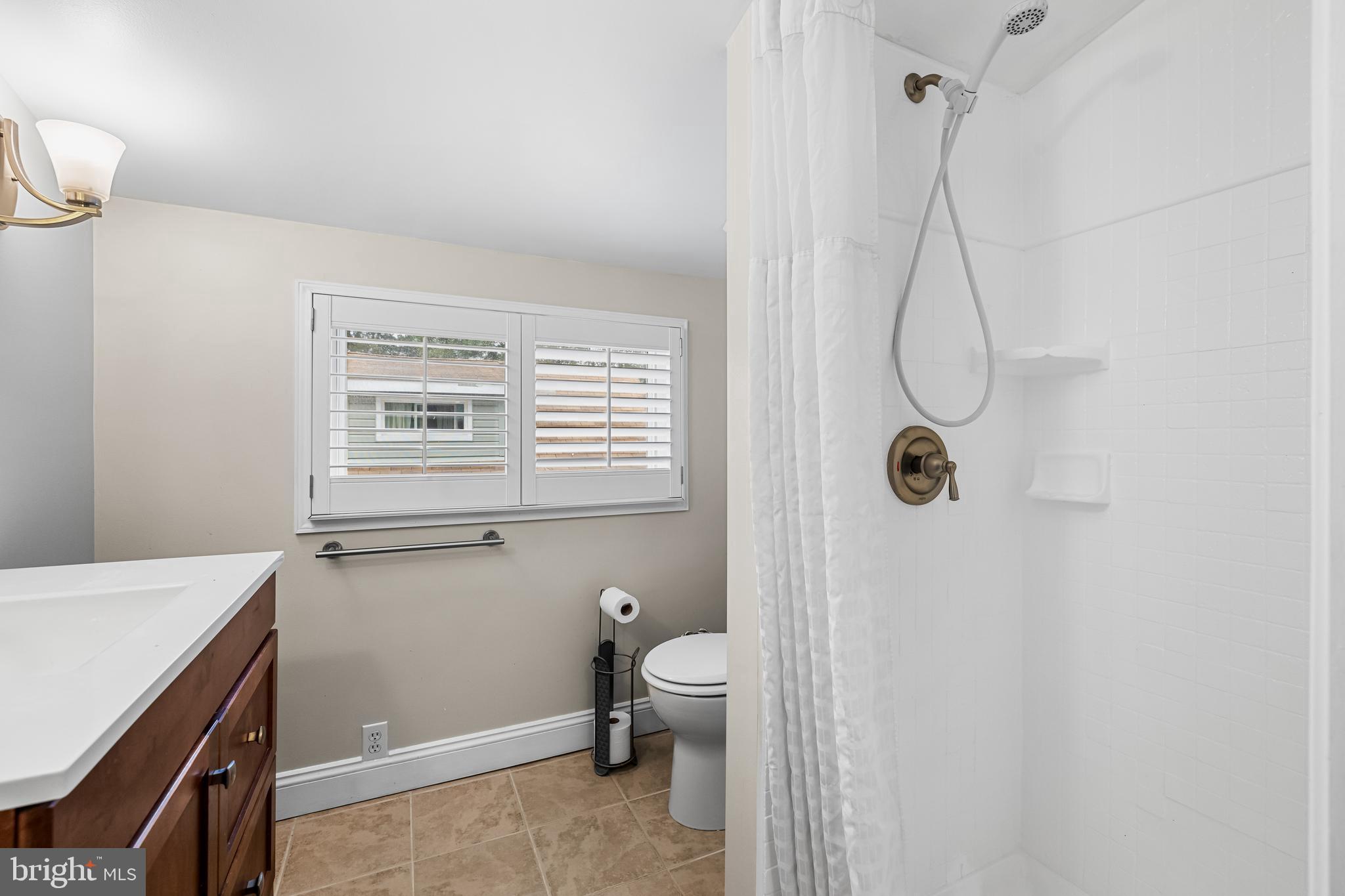 526 Hawthorne Road Linthicum Heights, MD 21090 - Photo 32 of 50 a bathroom with a granite countertop sink a toilet and shower