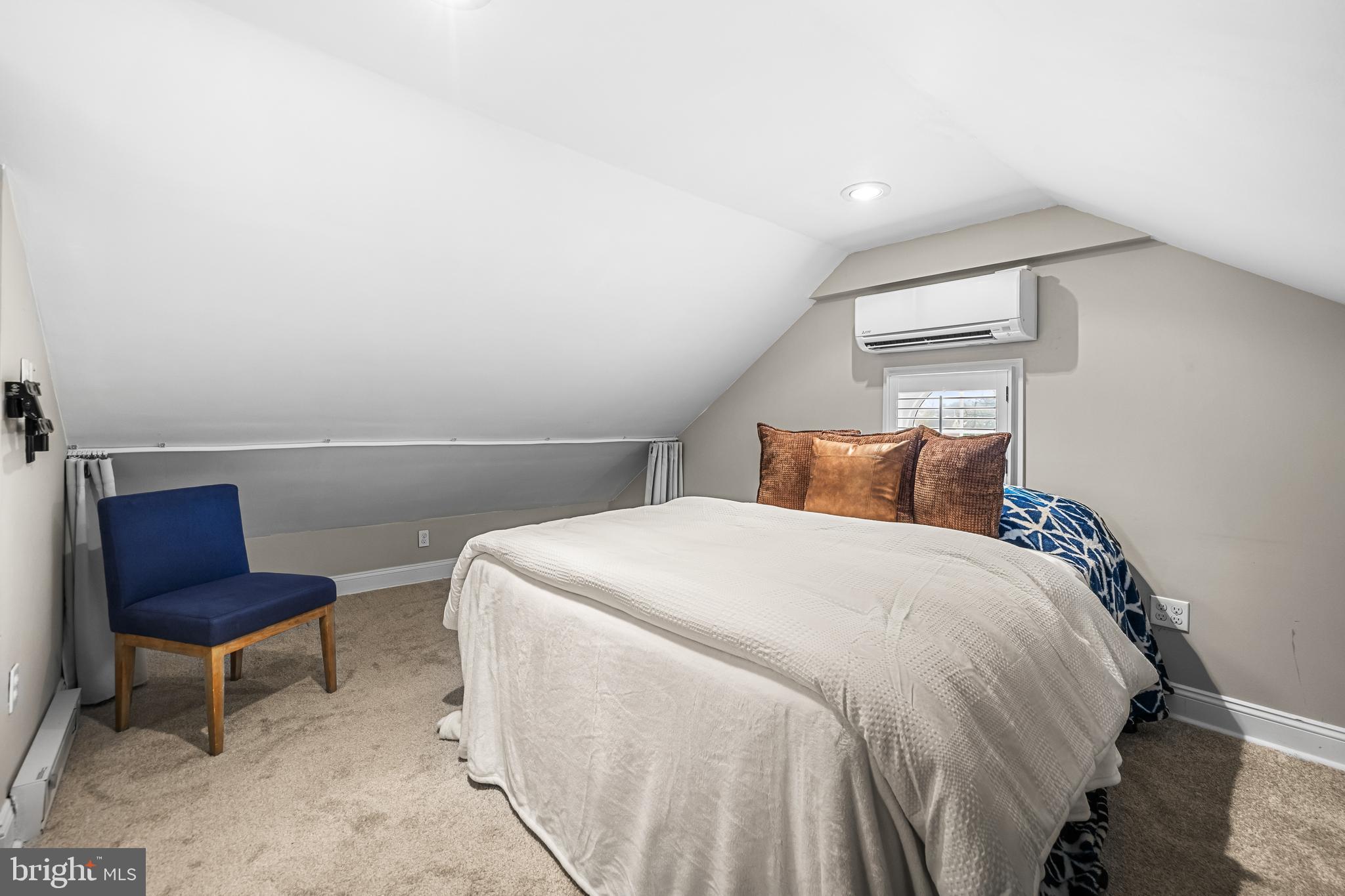 526 Hawthorne Road Linthicum Heights, MD 21090 - Photo 36 of 50 a bedroom with a bed a chair and a potted plant