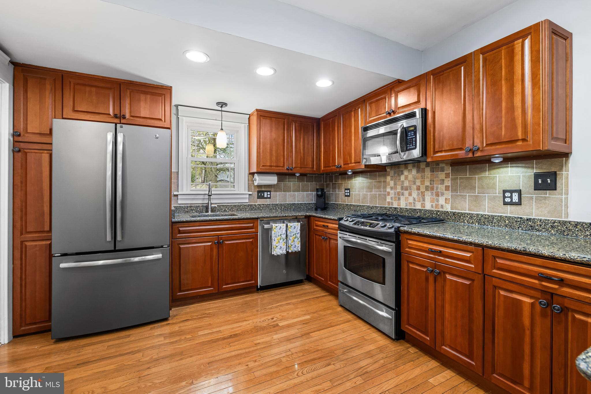 526 Hawthorne Road Linthicum Heights, MD 21090 - Photo 9 of 50 a kitchen with stainless steel appliances granite countertop a refrigerator stove top oven and sink
