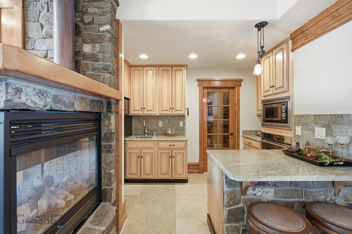 1240 Twin River Cutoff Road Manhattan, MT 59741 - Photo 45 of 88 Lower-level kitchen with door to wine cellar
