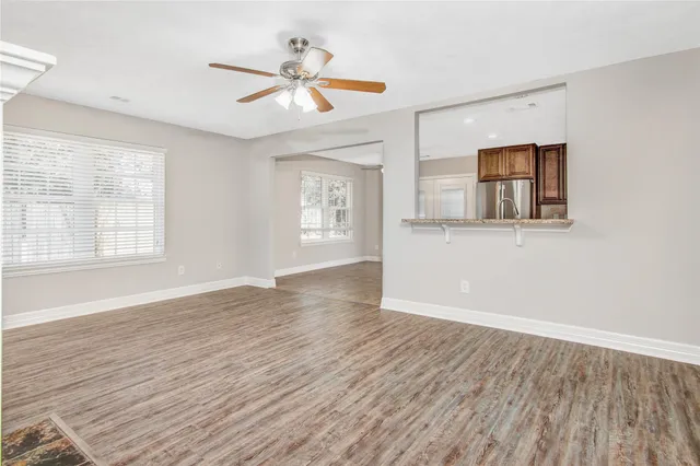 wooden floor in an empty room with a window