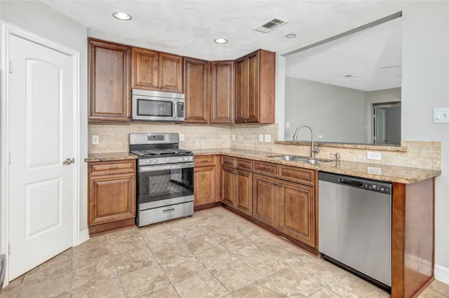 a kitchen with a sink stove and microwave