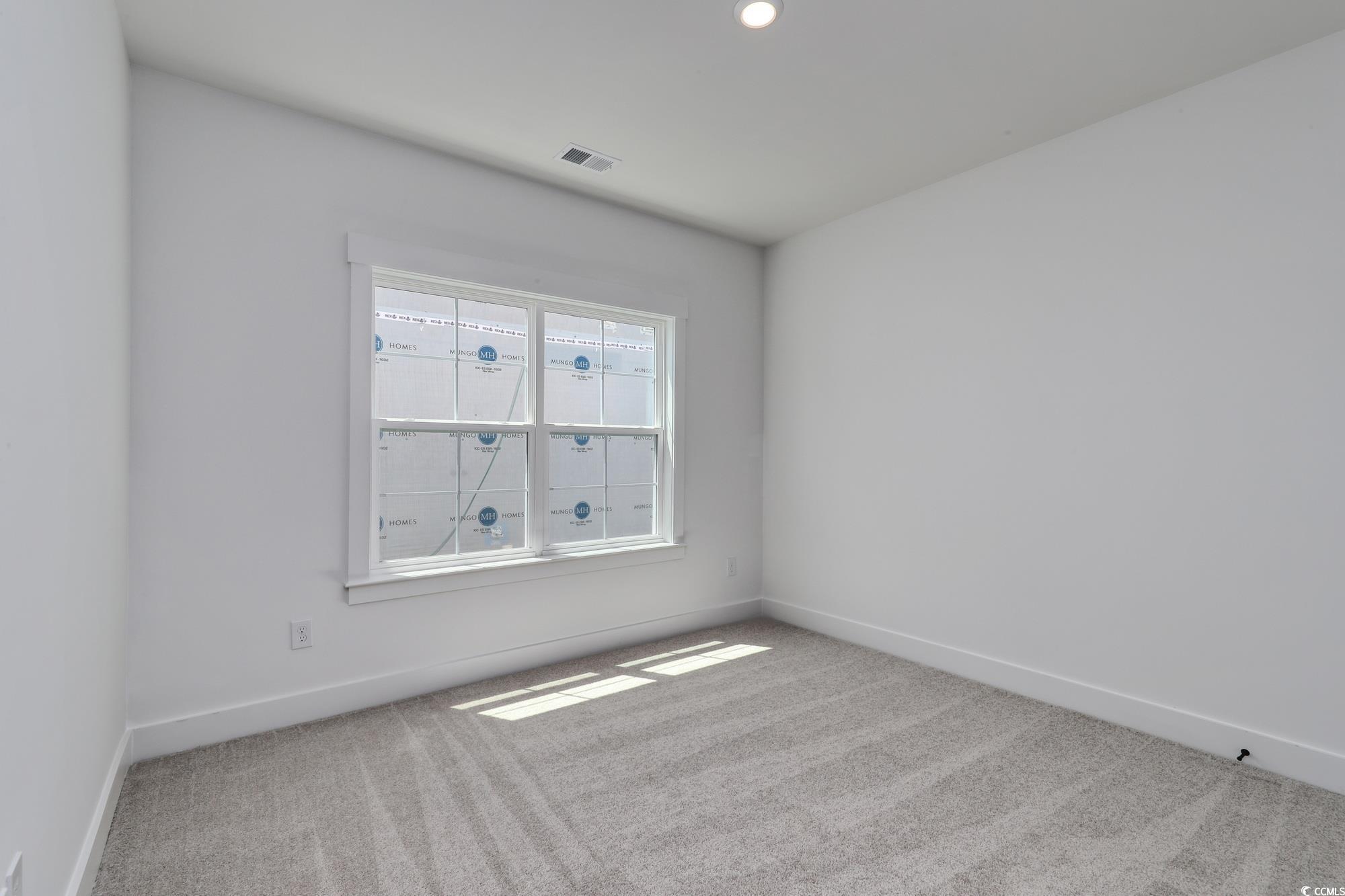 4028 Bucolic Loop Myrtle Beach, SC 29588 - Photo 11 of 40 Spare room featuring carpet floors, baseboards, an