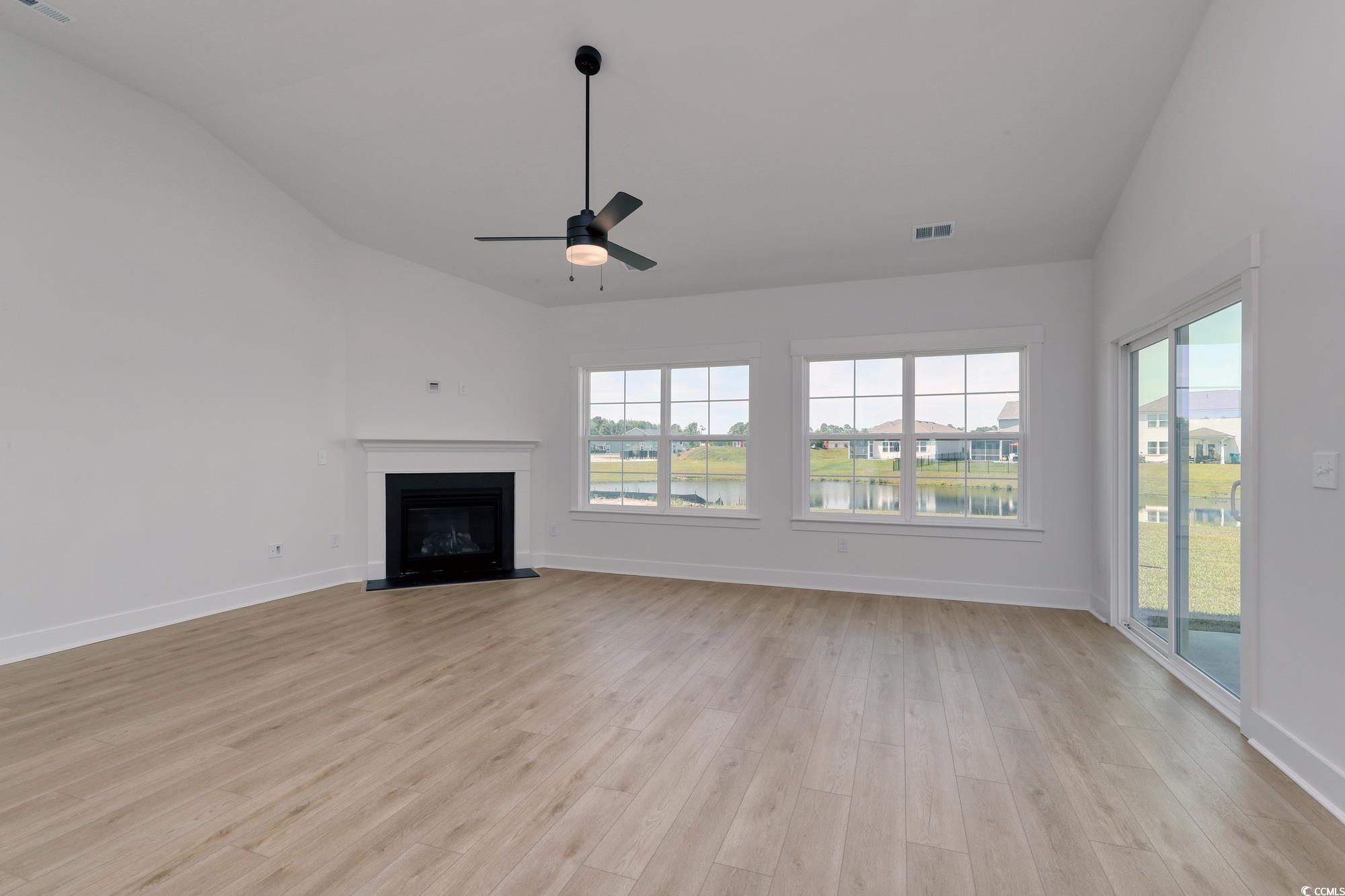4028 Bucolic Loop Myrtle Beach, SC 29588 - Photo 15 of 40 Unfurnished living room featuring vaulted ceiling,