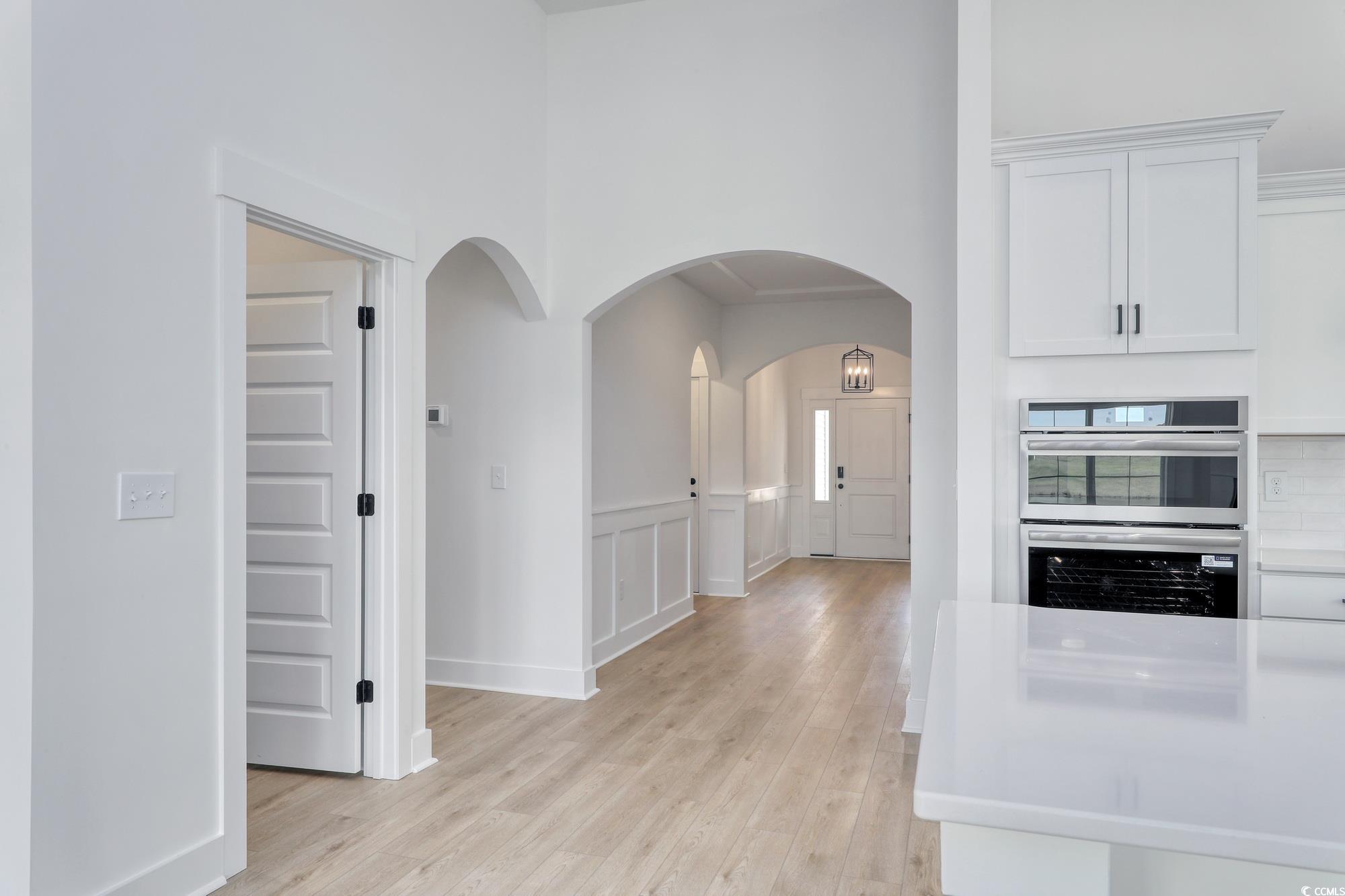 4028 Bucolic Loop Myrtle Beach, SC 29588 - Photo 16 of 40 Hall featuring light wood-style floors, arched wal