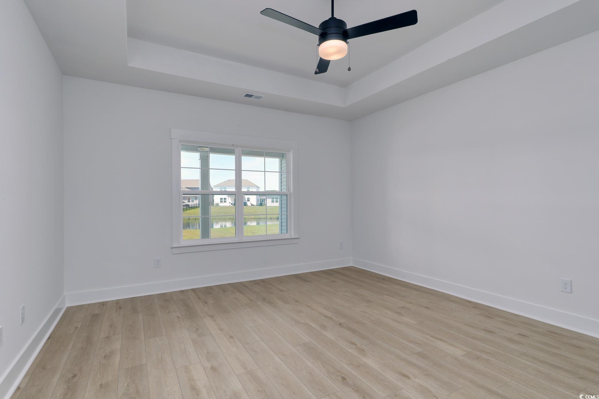 4028 Bucolic Loop Myrtle Beach, SC 29588 - Photo 24 of 40 Spare room with a raised ceiling, light wood finis