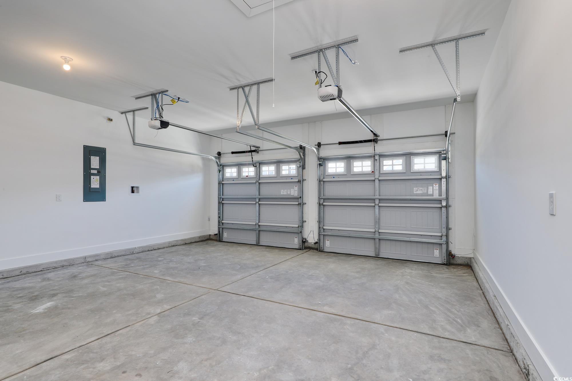 4028 Bucolic Loop Myrtle Beach, SC 29588 - Photo 6 of 40 Garage featuring electric panel, a garage door ope