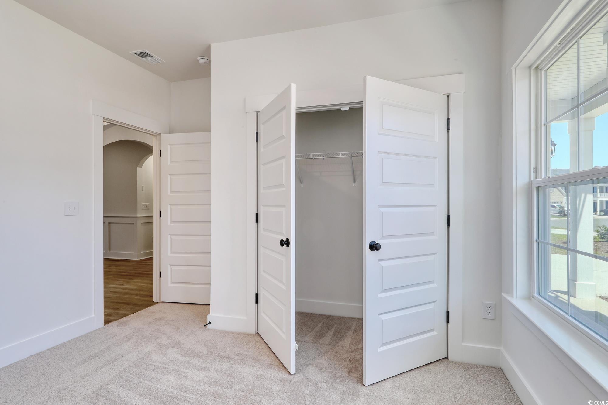 4028 Bucolic Loop Myrtle Beach, SC 29588 - Photo 8 of 40 Unfurnished bedroom featuring arched walkways, lig