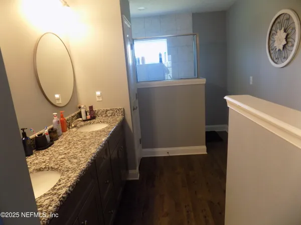 a bathroom with a granite countertop sink and a mirror