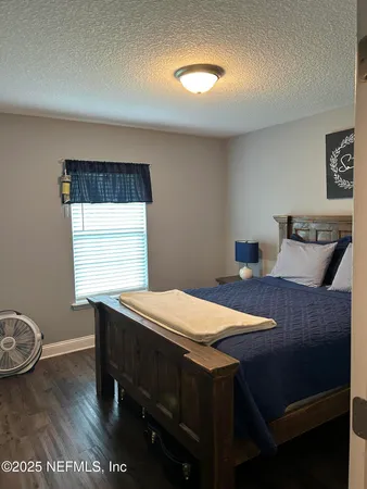 a room with a table chairs and wooden floor
