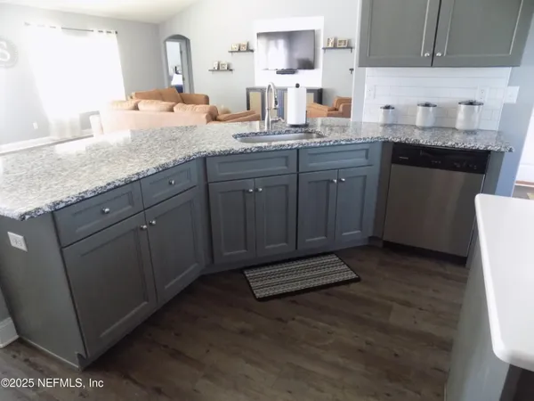 a kitchen with sink and cabinets