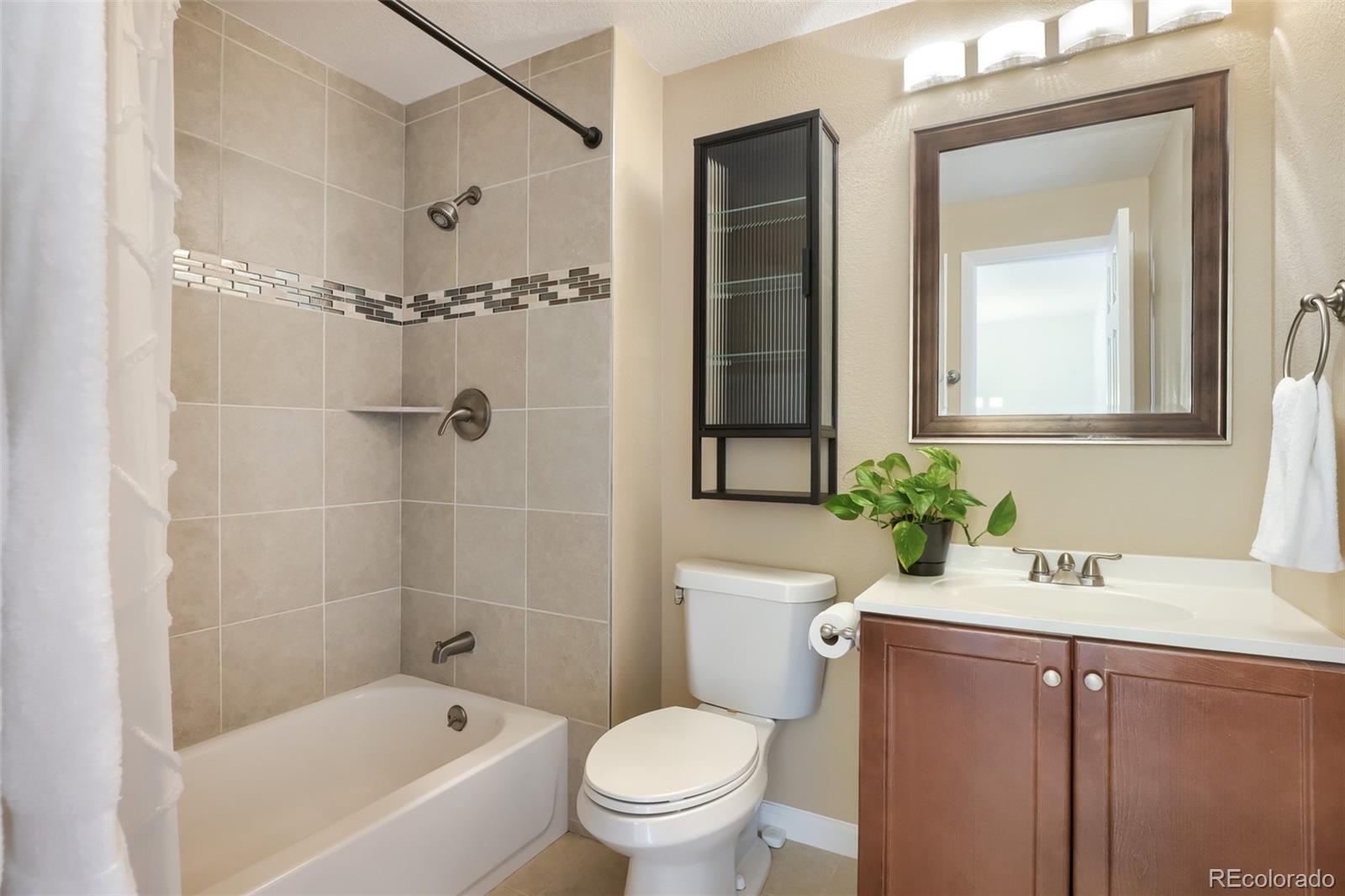 6551 South Albion Way Littleton, CO 80121 - Photo 13 of 37 a bathroom with a sink a toilet and shower