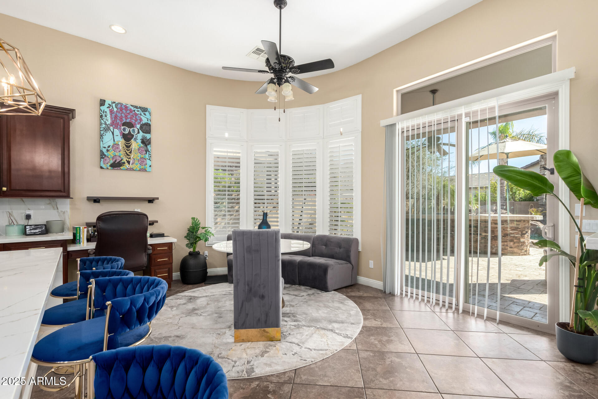 4935 West Yearling Road Phoenix, AZ 85083 - Photo 12 of 48 a living room with furniture a flat screen tv and a floor to ceiling window