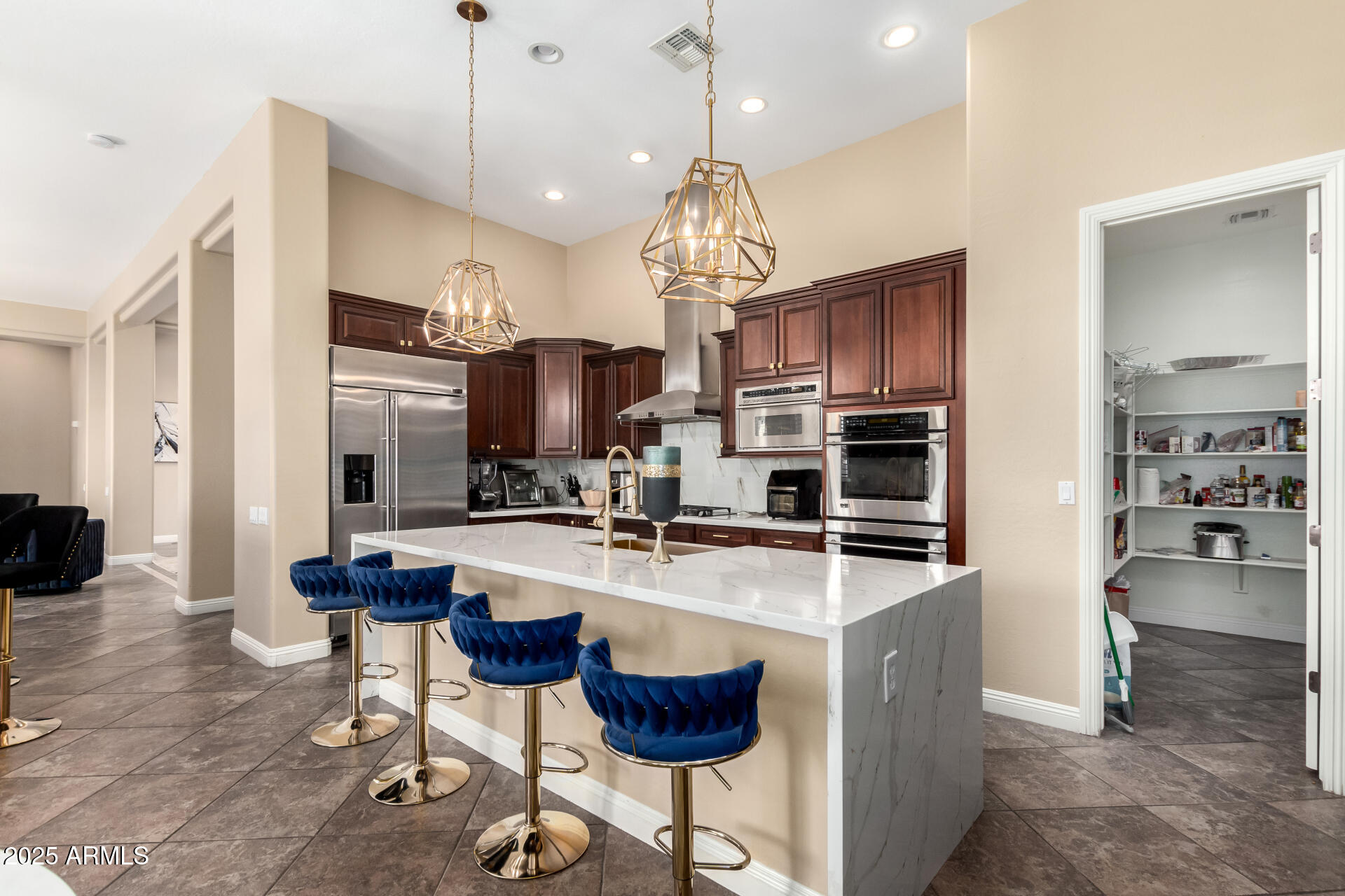 4935 West Yearling Road Phoenix, AZ 85083 - Photo 15 of 48 a kitchen with stainless steel appliances granite countertop a stove top oven a refrigerator a sink and chairs