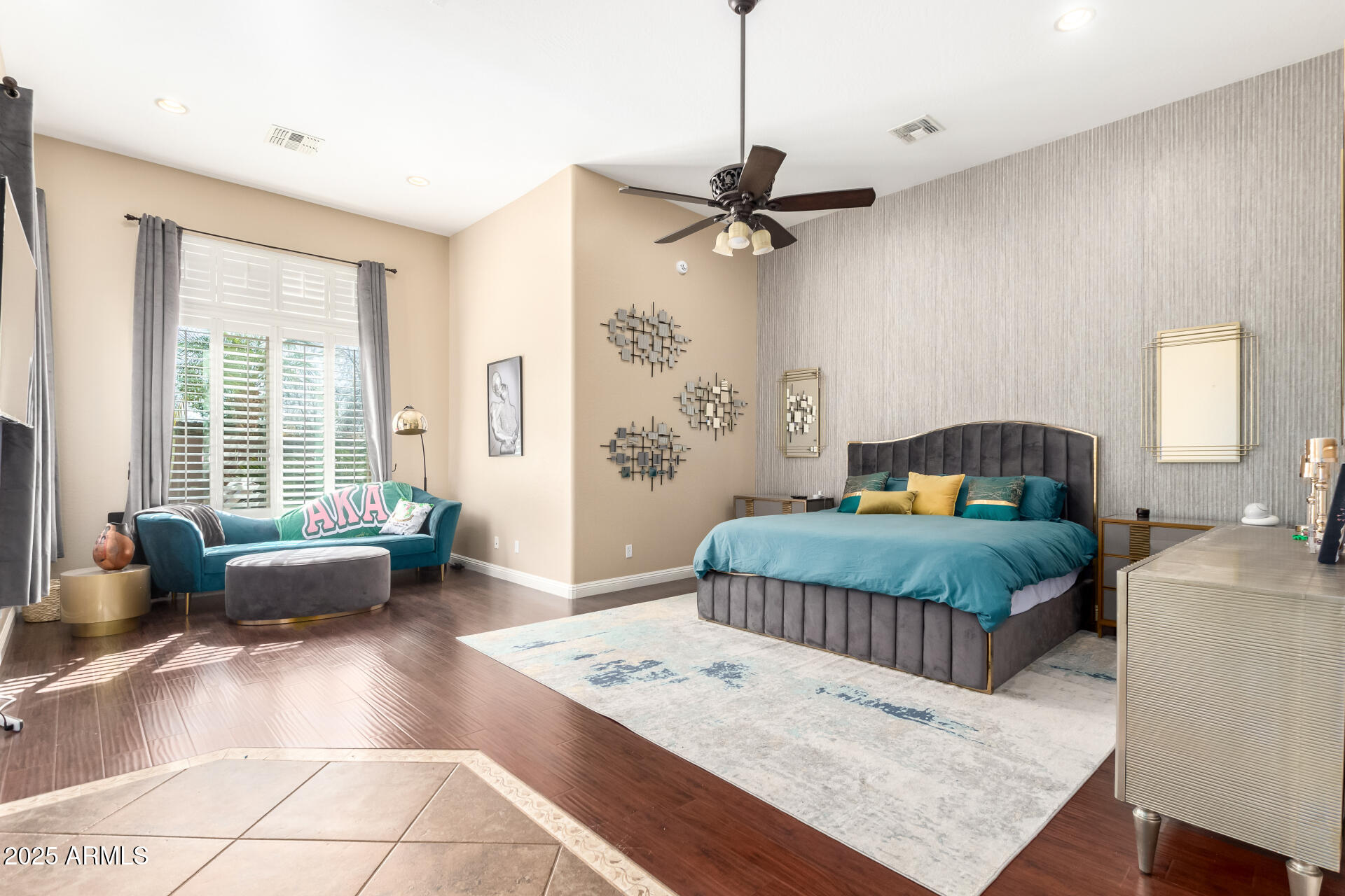 4935 West Yearling Road Phoenix, AZ 85083 - Photo 19 of 48 a bedroom with a bed a couch and a window