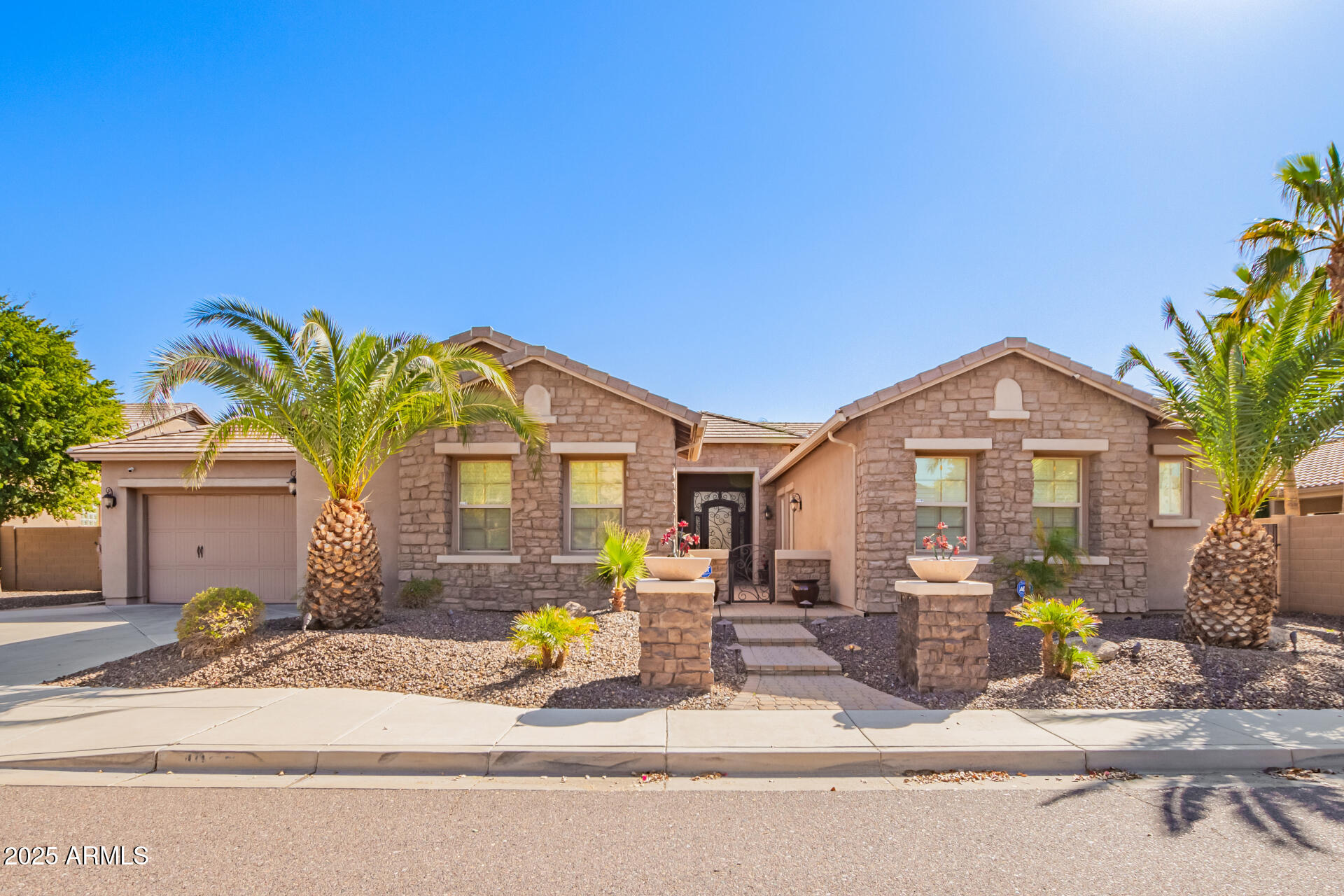 4935 West Yearling Road Phoenix, AZ 85083 - Photo 2 of 48 a front view of a house with a garden and patio