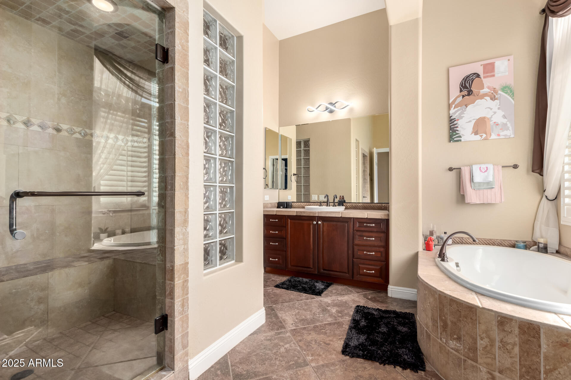 4935 West Yearling Road Phoenix, AZ 85083 - Photo 23 of 48 a bathroom with a tub a sink and mirrors