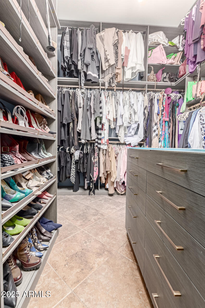4935 West Yearling Road Phoenix, AZ 85083 - Photo 26 of 48 a view of walk in closet with clothes and shoes
