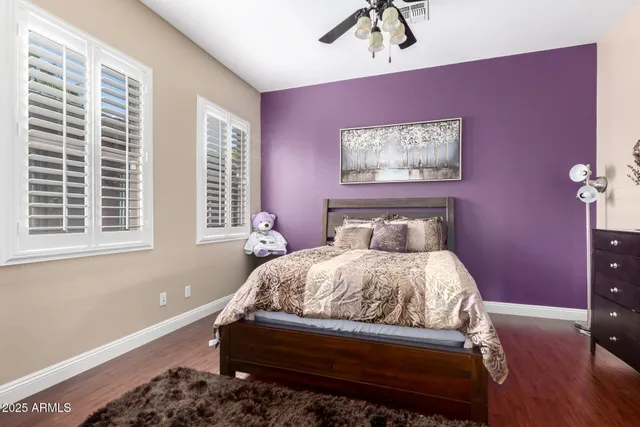 a bed sitting in a bedroom next to a window
