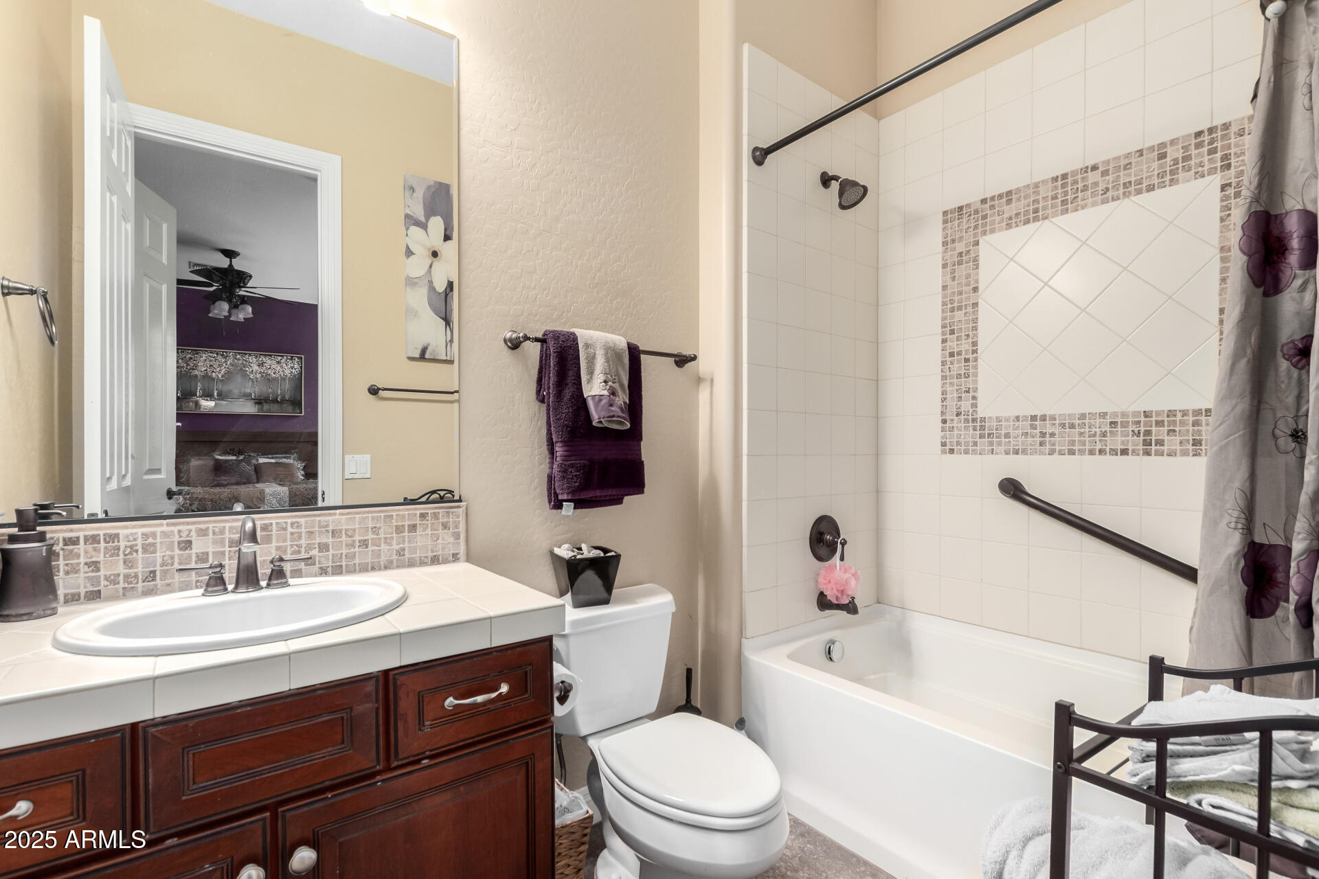 4935 West Yearling Road Phoenix, AZ 85083 - Photo 28 of 48 a bathroom with a sink a toilet a mirror a vanity and shower