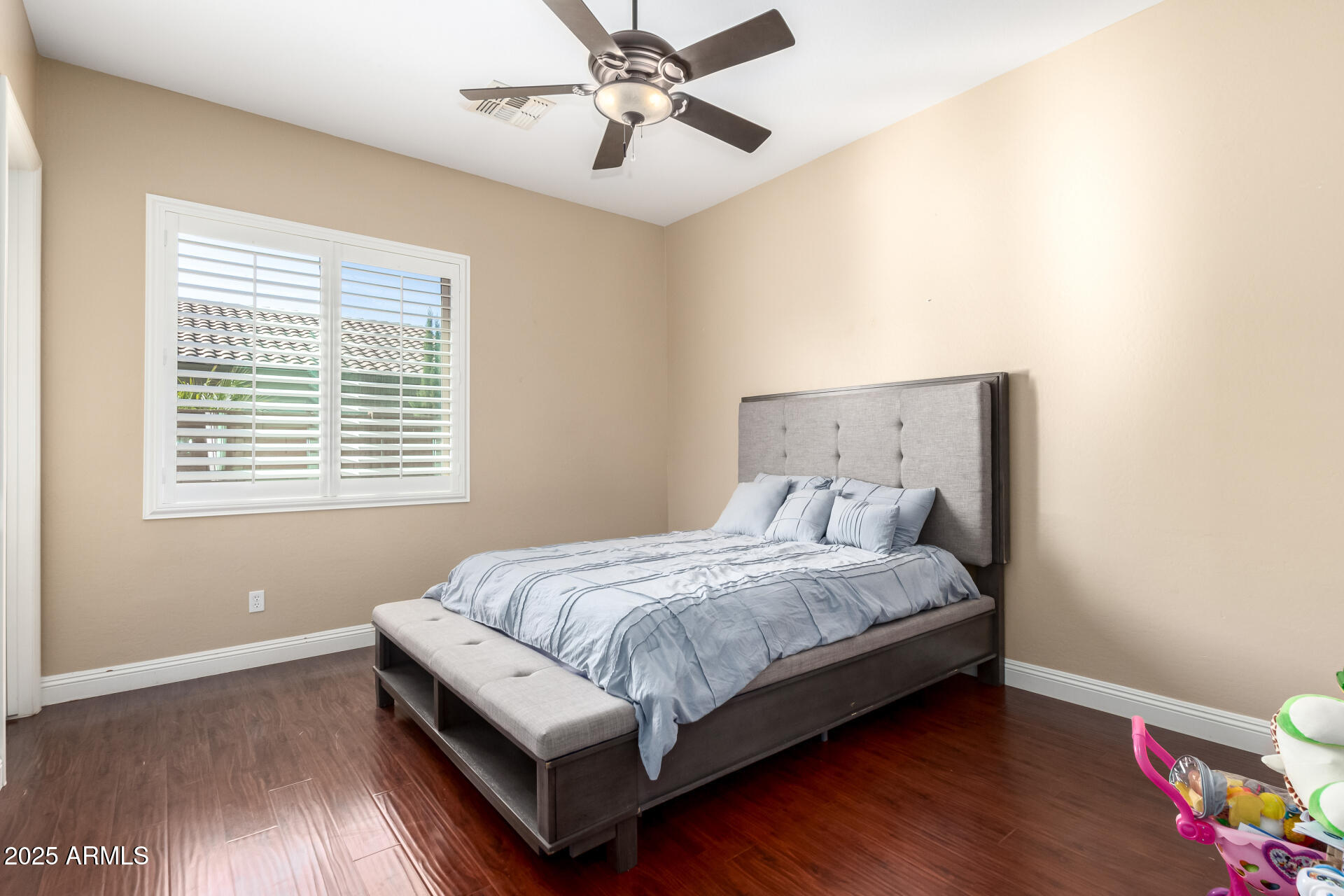 4935 West Yearling Road Phoenix, AZ 85083 - Photo 29 of 48 a bed sitting in a bedroom next to a window