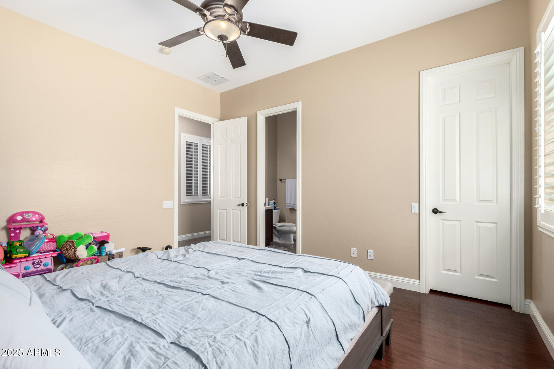 4935 West Yearling Road Phoenix, AZ 85083 - Photo 30 of 48 a bedroom with a bed and a chandelier