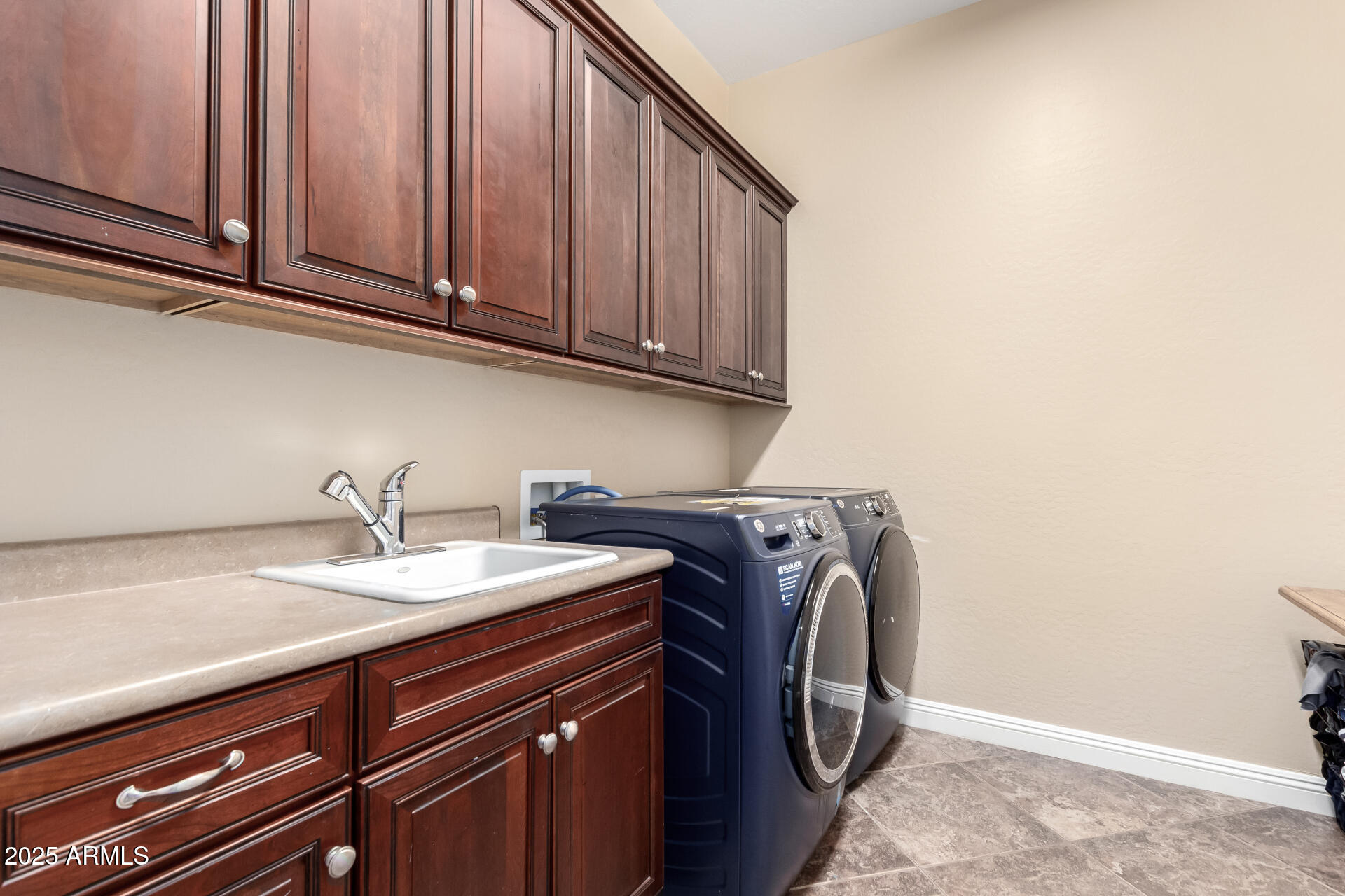 4935 West Yearling Road Phoenix, AZ 85083 - Photo 36 of 48 a utility room with granite countertop a sink and a washer dryer
