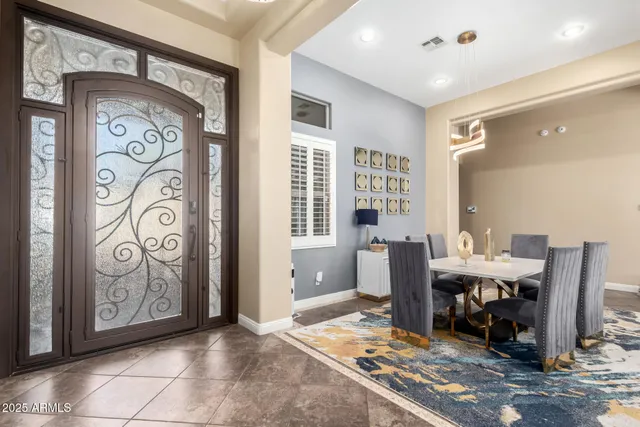 a living room with furniture and large windows