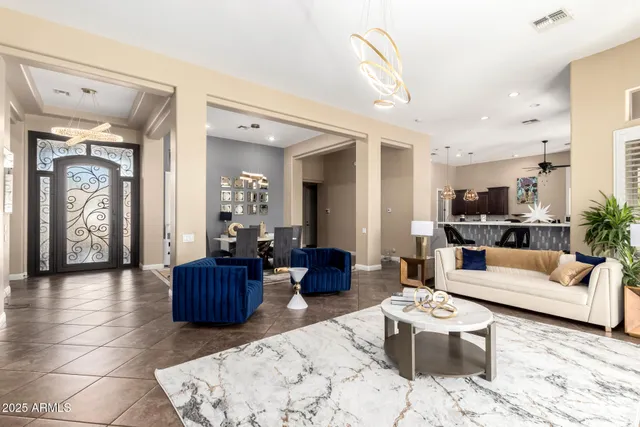 a living room with furniture a flat screen tv and a floor to ceiling window