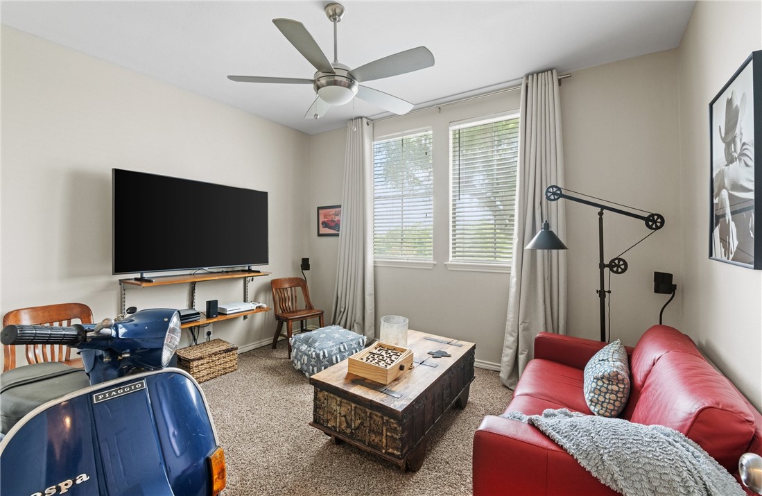 4658 Oso Parkway Corpus Christi, TX 78413 - Photo 13 of 33 a living room with furniture a flat screen tv and a window