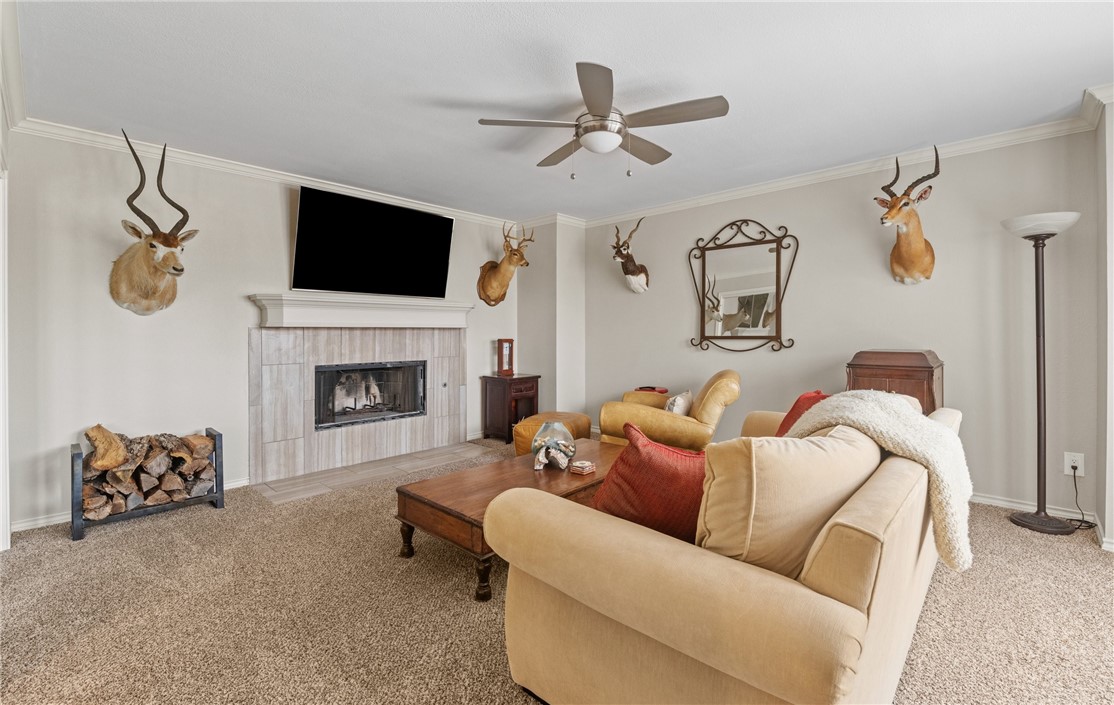 4658 Oso Parkway Corpus Christi, TX 78413 - Photo 21 of 33 a living room with furniture fireplace and a flat screen tv