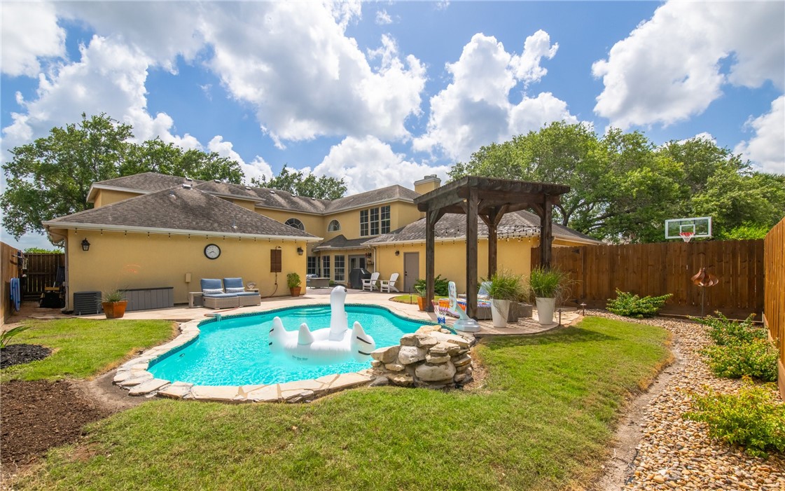 4658 Oso Parkway Corpus Christi, TX 78413 - Photo 26 of 33 a view of a house with swimming pool and yard