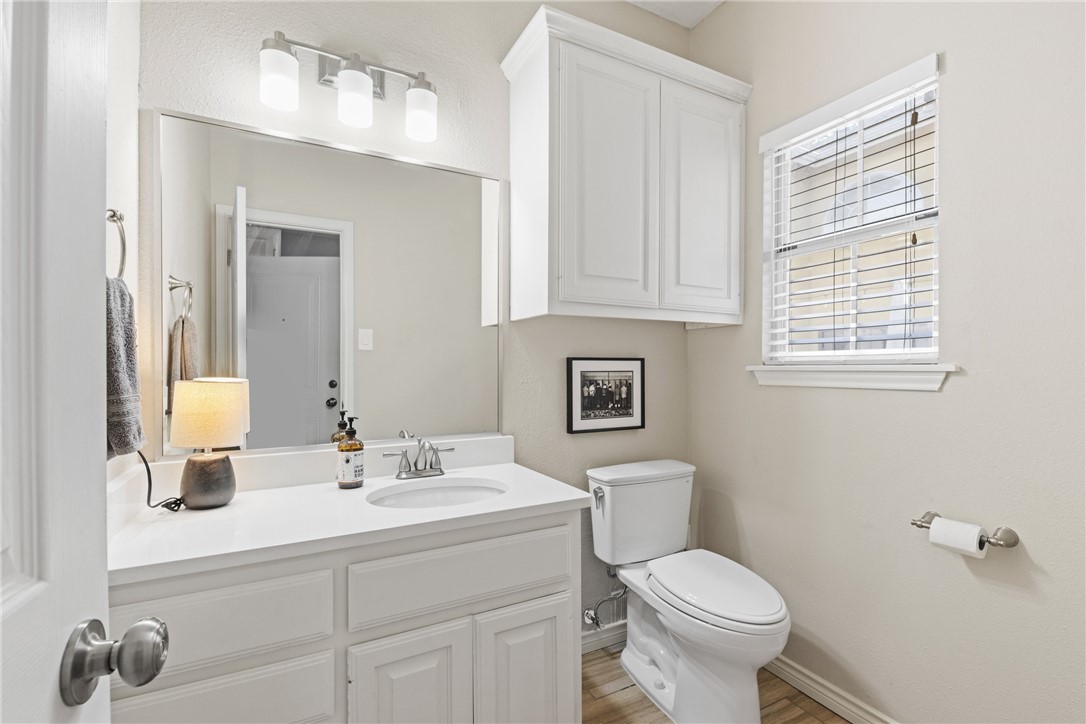 4658 Oso Parkway Corpus Christi, TX 78413 - Photo 10 of 33 a bathroom with a sink a toilet and mirror