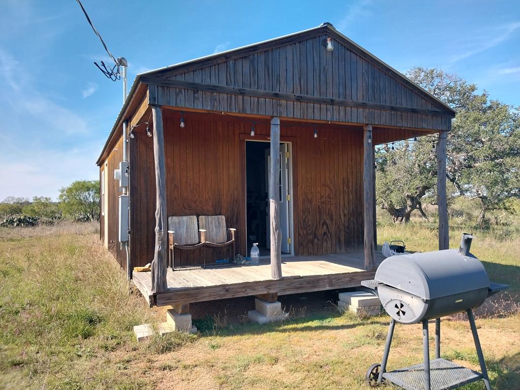 a backyard of a house with table and chairs