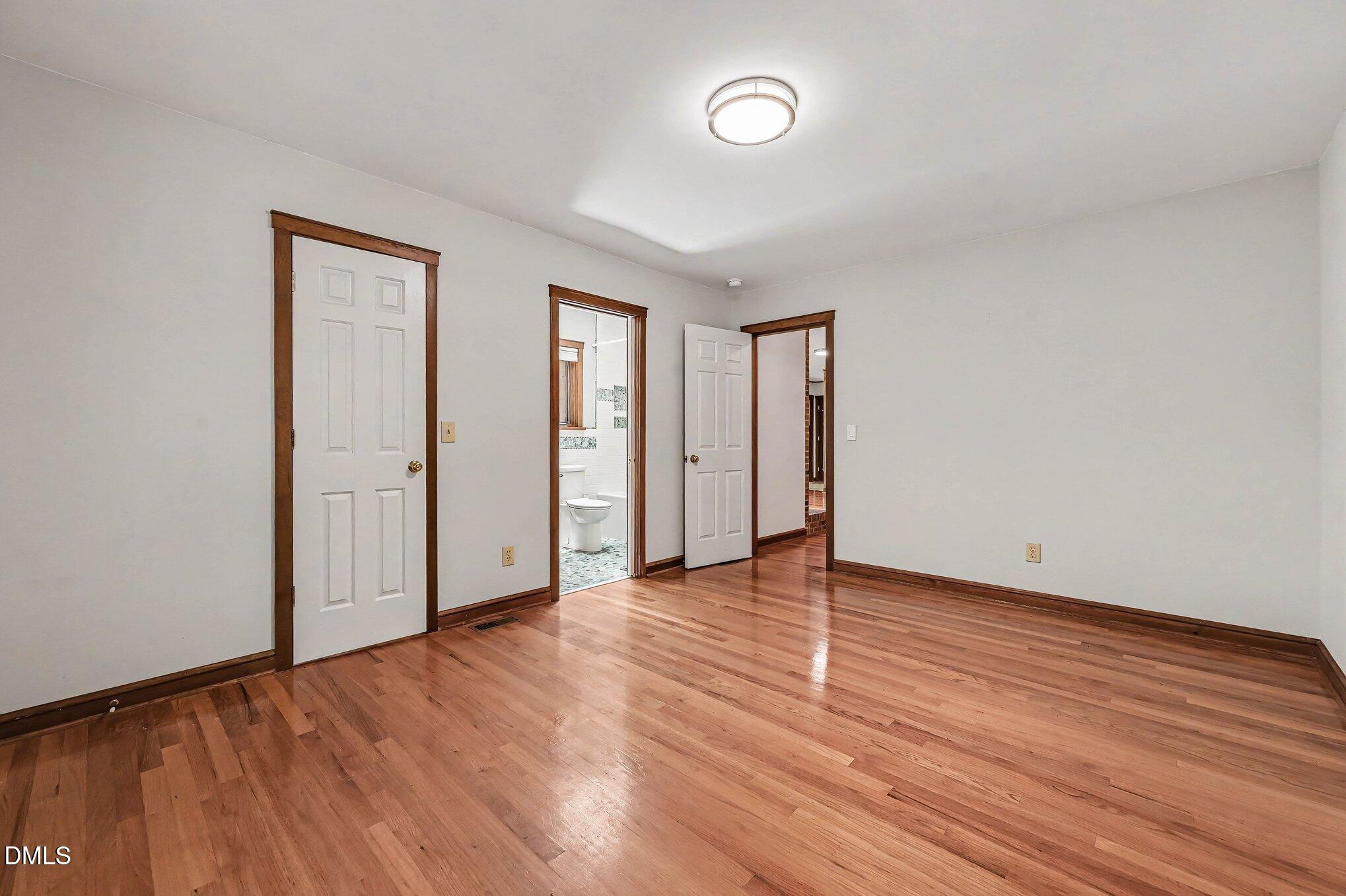 200 Spring Valley Road Carrboro, NC 27510 - Photo 19 of 38 a view of an empty room with wooden floor and closet